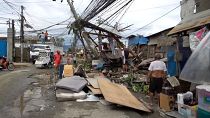 Damaged homes, flooding after typhoon hits Philippines