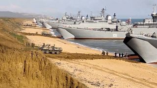 Russian troops board landing vessels after drills in Crimea in April 2021.