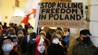 People demonstrate after the Polish parliament approved a bill that is widely viewed as an attack on media freedom, in Warsaw, Poland, Dec. 19, 2021. 