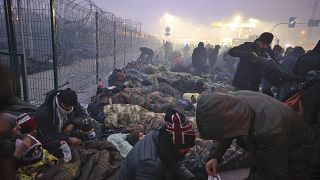 Migrants from the Middle East and elsewhere gather at the checkpoint "Kuznitsa" at the Belarus-Poland border near Grodno, Belarus, on Monday, Nov. 15, 2021.