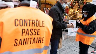 Security personnel check a COVID-19 health pass to access a Christmas market in Strasbourg, eastern France, Dec 3, 2021. 