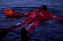 Swimmers stay warm and dry whilst floating in a frozen lake