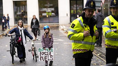 young people protesting in London ahead of the 26th U.N. Climate Change Conference (COP26). young people protesting in London ahead of the 26th U.N. Climate Change Conference (COP26).