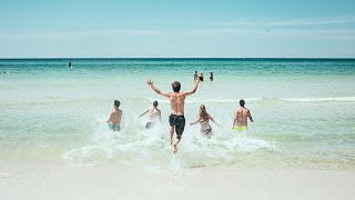 People jump into the sea