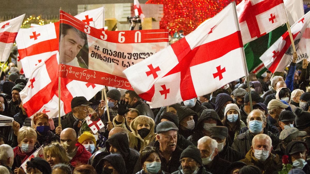 Georgian opposition demonstrators attend a rally in support of former President Mikheil Saakashvili in Tbilisi, Georgia, Tuesday, Dec. 21, 2021.