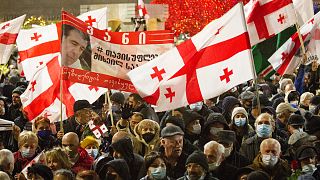 Georgian opposition demonstrators attend a rally in support of former President Mikheil Saakashvili in Tbilisi, Georgia, Tuesday, Dec. 21, 2021.