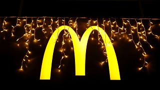 Christmas lights are hung above the logo outside a McDonald's restaurant in Lisbon, Dec. 14, 2021.