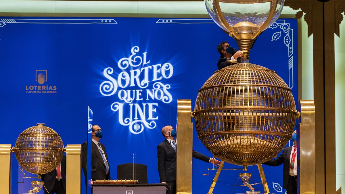 Workers prepare numbered lottery balls at Madrid's Teatro Real opera house during Spain's bumper Christmas lottery draw known as The Fat One, in Madrid, Spain, Dec. 22, 2021.