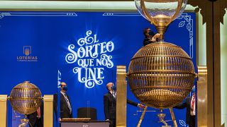 Workers prepare numbered lottery balls at Madrid's Teatro Real opera house during Spain's bumper Christmas lottery draw known as The Fat One, in Madrid, Spain, Dec. 22, 2021.
