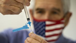 Dr. Sydney Sewall fills a syringe with the COVID-19 vaccine at the Augusta Armory, Tuesday, Dec. 21, 2021, in Augusta, Maine, USA.