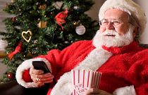 Santa Claus enjoying some Christmas movies.