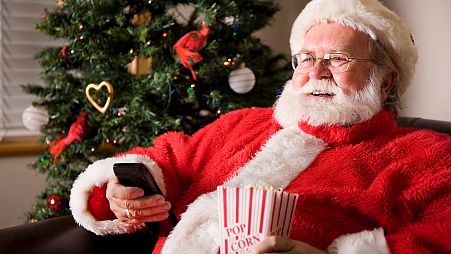 Santa Claus enjoying some Christmas movies. 