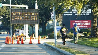 People walk past a sign announcing Astroworld is canceled outside NRG in Houston on Nov. 6, 2021.
