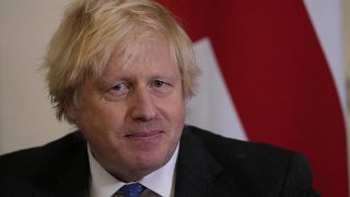 British Prime Minister Boris Johnson watches journalists as he welcomes the Sultan of Oman, Haitham Bin Tarik Al Said, to 10 Downing Street in London, Dec. 16, 2021.