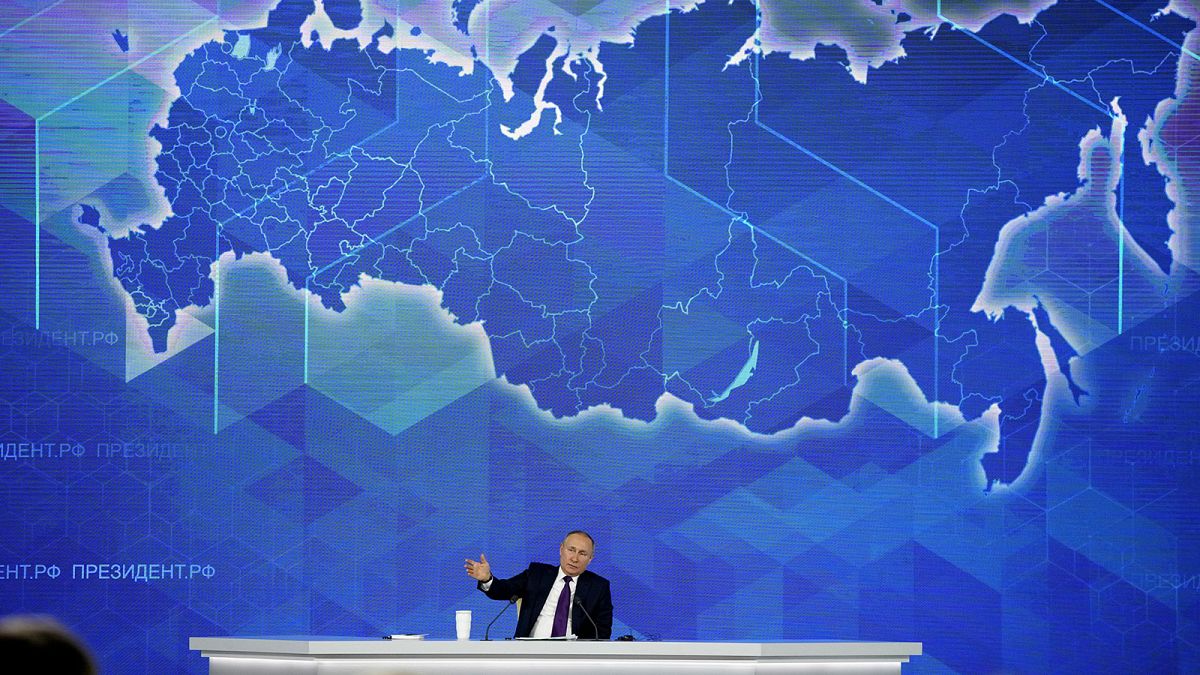 Russian President Vladimir Putin gestures while speaking during his annual news conference in Moscow