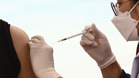 A man receives a Covid-19 coronavirus vaccine at the Bang Sue Central Vaccination Centre in Bangkok