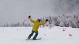 A tourist gestures while skiing, at Plan de Corones ski area, Italy South Tyrol, Saturday, Nov. 27, 2021.