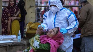 ممرض يجري فحصا لسيدة في سوق جامو في الهند