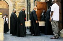 Clerics carry the coffin of Anglican Archbishop Emeritus Desmond Tutu at the St. George's Cathedral where he will lie in state for two days in Cape Town, South Africa.