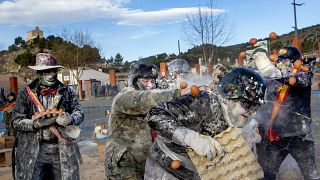 Revellers take part in the Els Enfarinats festival, in the town of Ibi near Alicante, Spain, Tuesday 28 Dec, 2021 