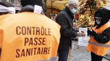Security personnel check a COVID-19 health pass to access a Christmas market in Strasbourg, eastern France, Friday, Dec 3, 2021.