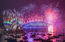 Fireworks explode over the Sydney Opera House and Harbour Bridge as New Year celebrations begin in Sydney, Australia, Friday, Jan. 1, 2021.