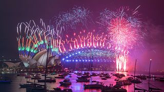 Fireworks explode over the Sydney Opera House and Harbour Bridge as New Year celebrations begin in Sydney, Australia, Friday, Jan. 1, 2021.