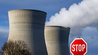 Steam rises from the cooling tower of the nuclear power plant of Gundremmingen, Bavaria, Friday, Dec. 31, 2021. 