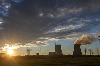 Steam rises from the cooling tower of the nuclear power plant of Gundremmingen, Bavaria, Germany, Friday, Dec. 31, 2021.