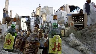 Booze bottles are piled up on rock to be smashed by Taliban authorites in Kabul, Afghanistan, Tuesday, Aug.28, 2001.