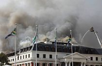 Smoke rises from the Parliament in Cape Town, South Africa, Monday, Jan 3, 2022 after the fire re-ignited late afternoon.