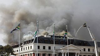 Smoke rises from the Parliament in Cape Town, South Africa, Monday, Jan 3, 2022 after the fire re-ignited late afternoon.