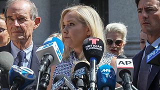 In this Aug. 27, 2019 file photo, Virginia Giuffre, center, who says she was trafficked by sex offender Jeffrey Epstein, outside a Manhattan court in New York.