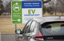 A Nissan Leaf charges at a recharge station outside the Denver Museum of Nature and Science Friday, Dec. 24, 2021.
