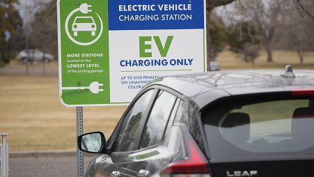 A Nissan Leaf charges at a recharge station outside the Denver Museum of Nature and Science Friday, Dec. 24, 2021.
