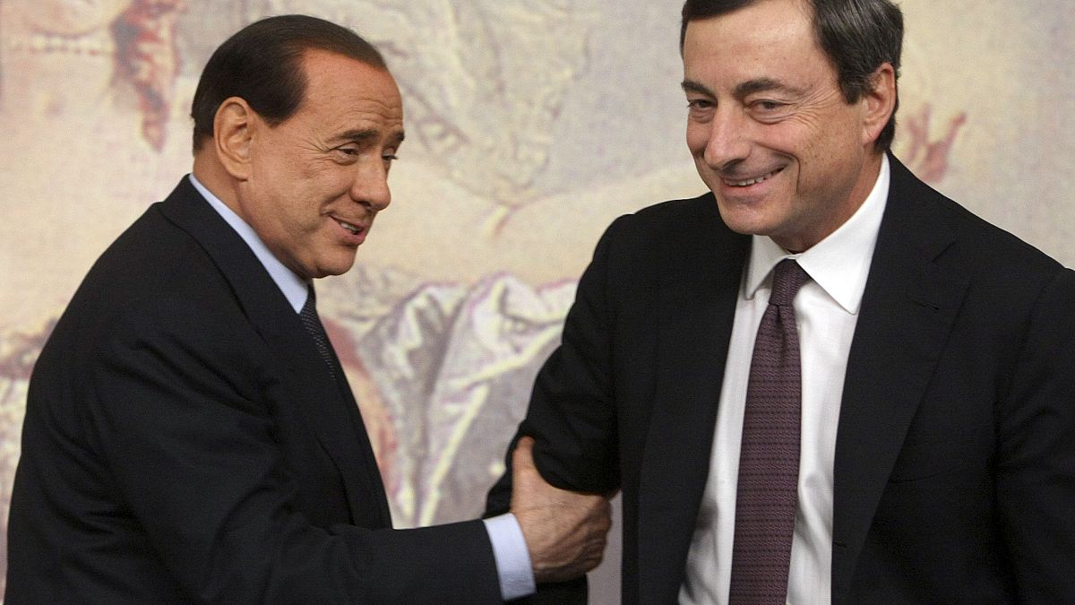 Former and present Italian Premiers Silvio Berlusconi, left, and Mario Draghi, right, are seen during a press conference at Chigi Palace,in Rome, on Oct. 8, 2008