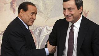 Former and present Italian Premiers Silvio Berlusconi, left, and Mario Draghi, right, are seen during a press conference at Chigi Palace,in Rome, on Oct. 8, 2008