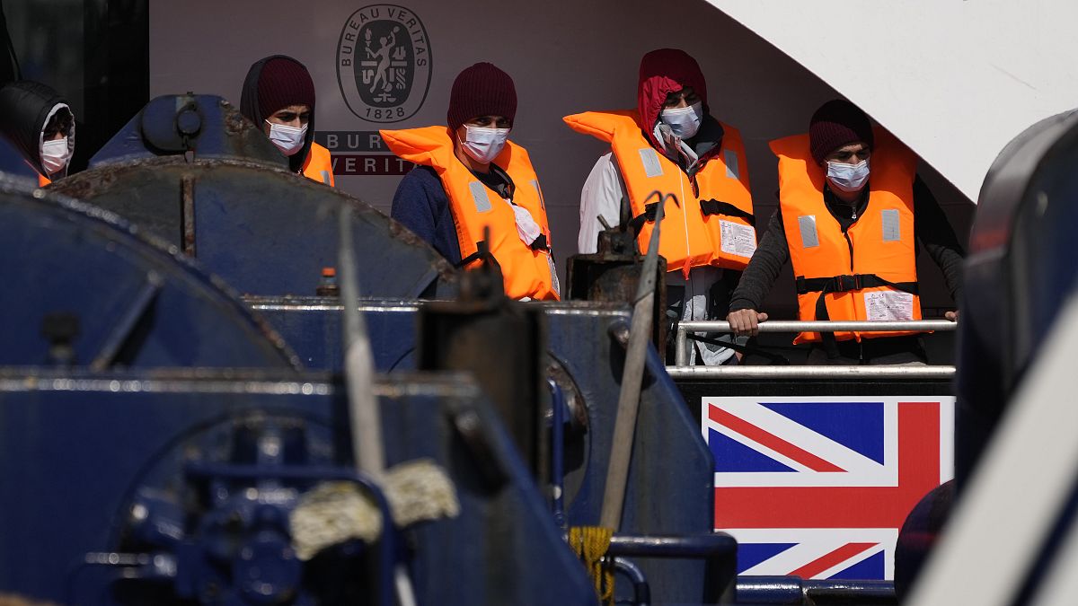People thought to be migrants who made the crossing from France wait as they are disembarked from a British border force vessel, in Dover, England, Sept. 10, 2021.