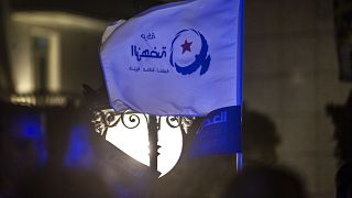 متظاهر يرفع علم حزب النهضة الإسلامي في تونس. 