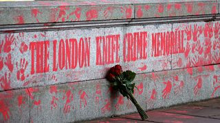 A bouquest is left at a mural to highlight knife crime in London on April 30, 2021.