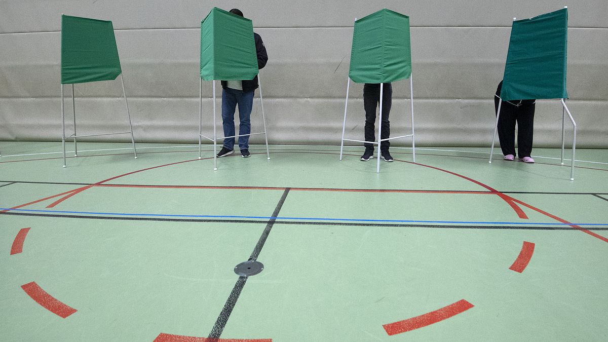 People vote at a polling station during the European Parliament elections in Lund, Sweden.