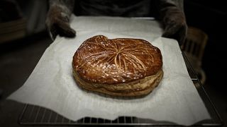 French baker Aurelie Ribay presents a Galette des Rois (French Epiphany cake) January 8, 2020 at her bakery in Paris.