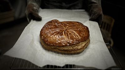 French baker Aurelie Ribay presents a Galette des Rois (French Epiphany cake) January 8, 2020 at her bakery in Paris.