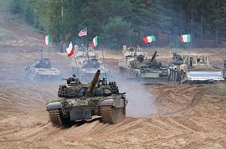 Military vehicles and tanks of Poland, Italy, Canada and United States roll during the NATO military exercises ''Namejs 2021'' at a training ground in Kadaga, Latvia,
