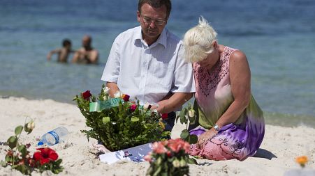 Mourners on the site of the 2015 terror attack on a beach in Tunisia.