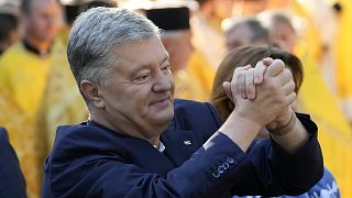 Ukraine's former President Petro Poroshenko greets his supporters before a Mass at the St.Sofia Cathedral in Kyiv in August 2021