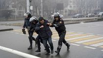 Police officers detain a demonstrator during a protest in Almaty, Kazakhstan, Wednesday, Jan. 5, 2022