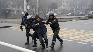 Police officers detain a demonstrator during a protest in Almaty, Kazakhstan, Wednesday, Jan. 5, 2022