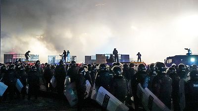 Riot police block protesters in the center of Almaty, Kazakhstan, Wednesday, Jan. 5, 2022.