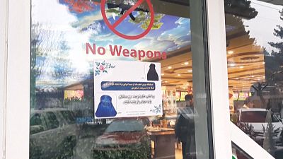 Notices on Kabul shop windows call for Afghan women to cover up